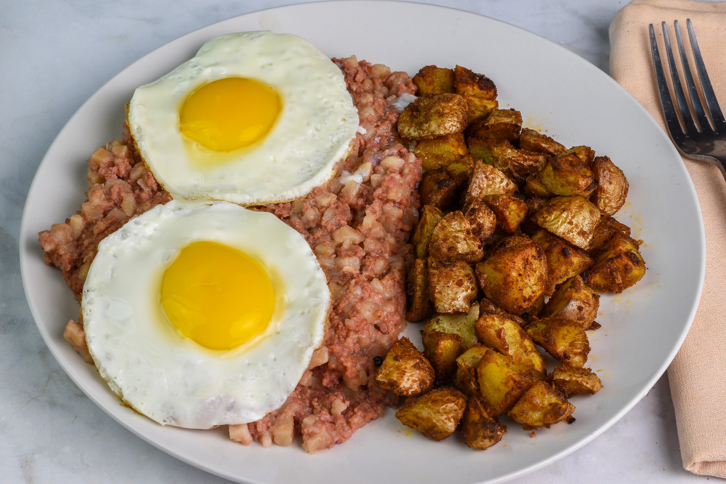 fried eggs n corn beef hash and home fries