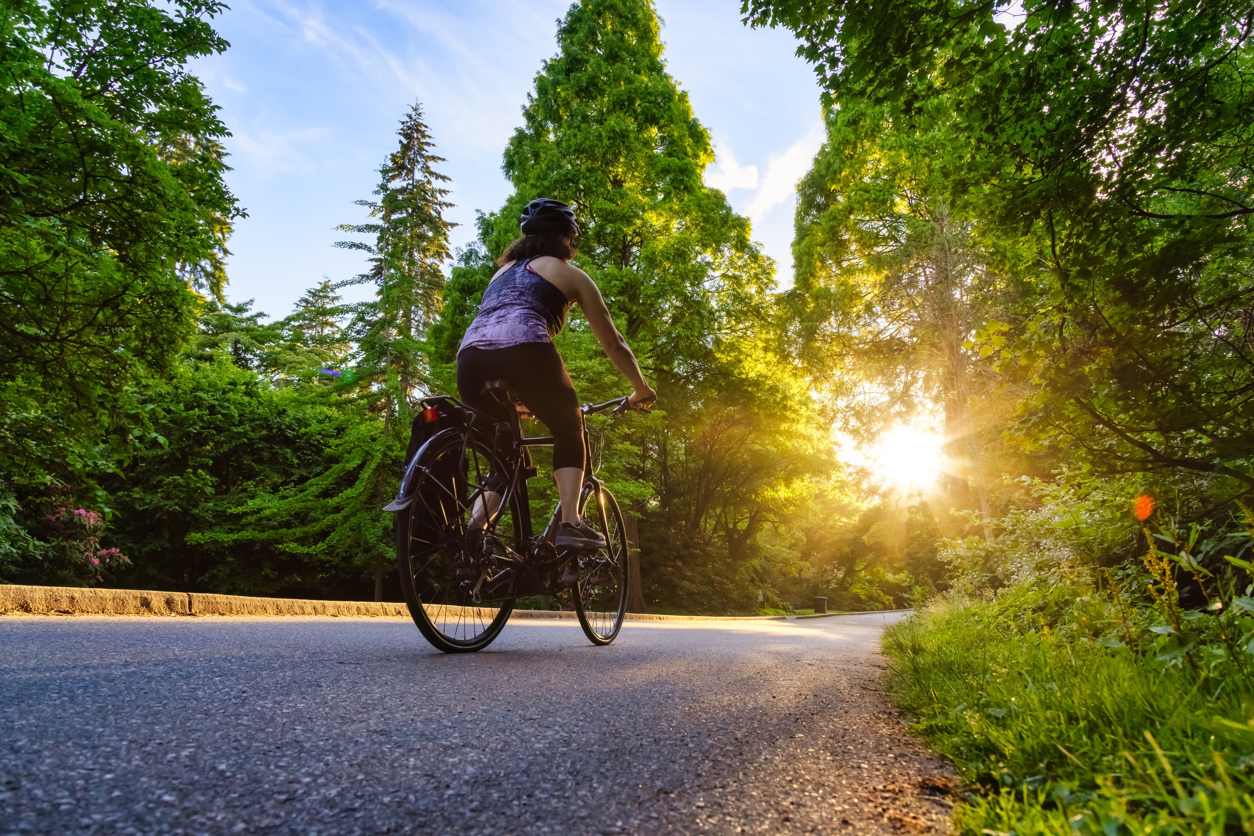 Adventurous White Caucasian Adult Woman riding a road bicycle